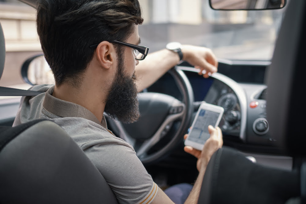 man using mobile phone while driving