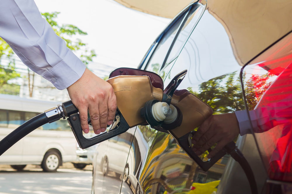 man putting gasoline fuel into his car pump gas station 1